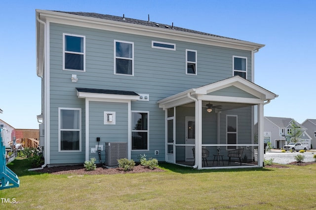 back of property featuring a lawn, central AC, and a sunroom