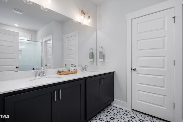 bathroom with a shower with door and vanity