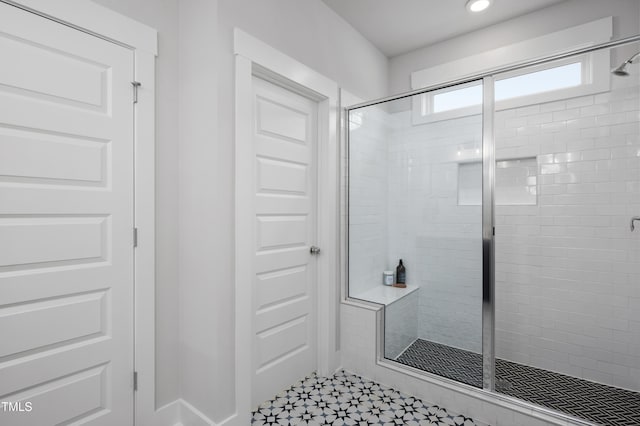 bathroom featuring a shower with shower door