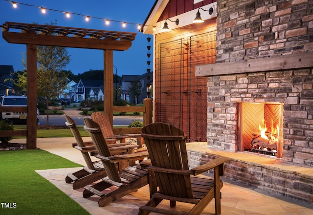 view of patio featuring an outdoor brick fireplace