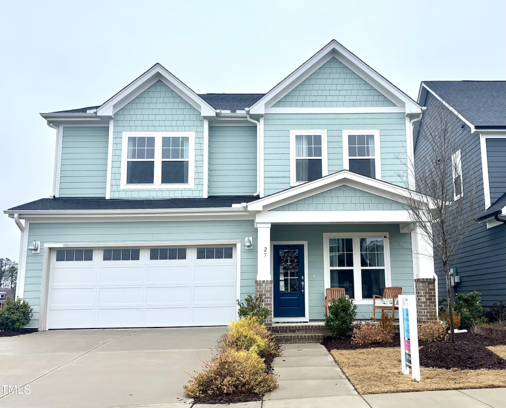 craftsman-style home featuring a garage and covered porch