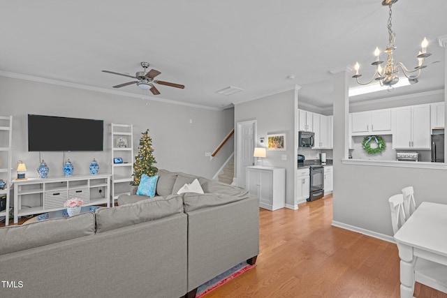 living room with ceiling fan with notable chandelier, light wood-type flooring, and ornamental molding