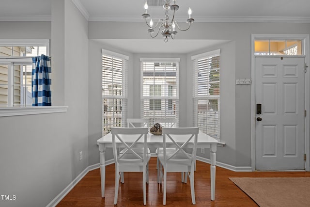 unfurnished dining area with ornamental molding, hardwood / wood-style flooring, and a notable chandelier