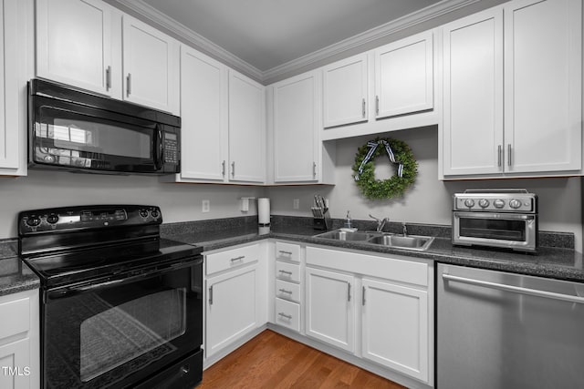 kitchen with ornamental molding, sink, black appliances, hardwood / wood-style floors, and white cabinetry