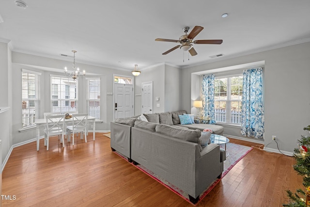 living room with crown molding, hardwood / wood-style floors, and ceiling fan with notable chandelier