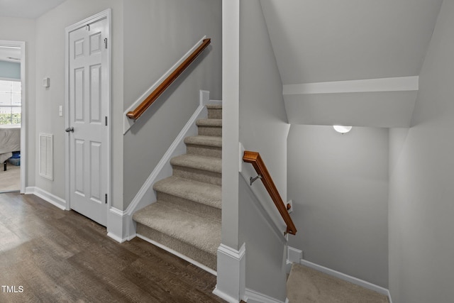 stairway featuring wood-type flooring