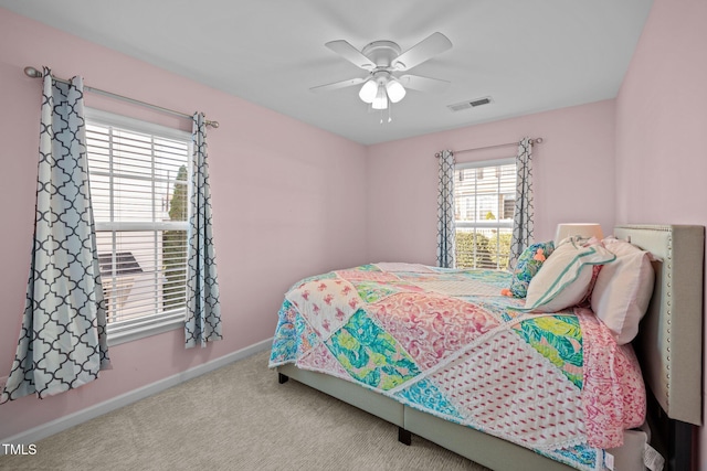 bedroom with light carpet and ceiling fan