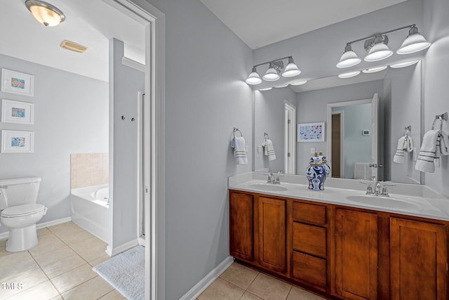 bathroom featuring tile patterned flooring, vanity, toilet, and a washtub