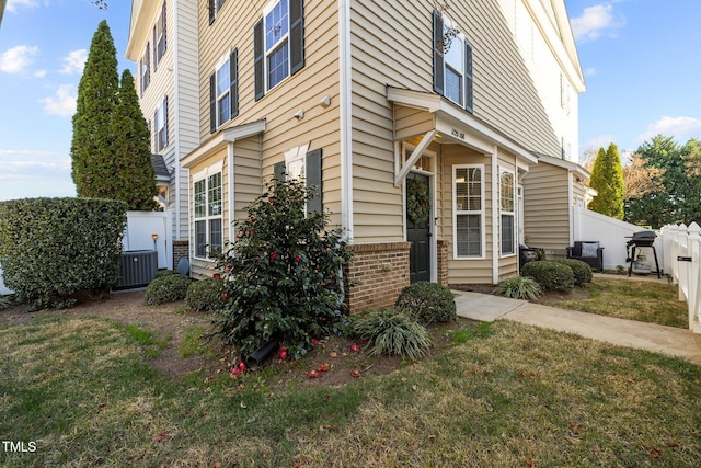 exterior space with a yard and central air condition unit