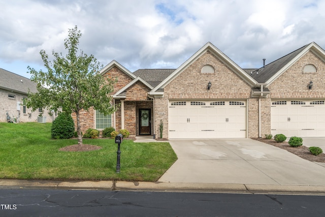 view of front of house with a front yard and a garage