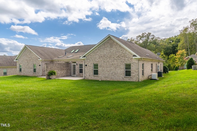 rear view of property with a yard and a patio