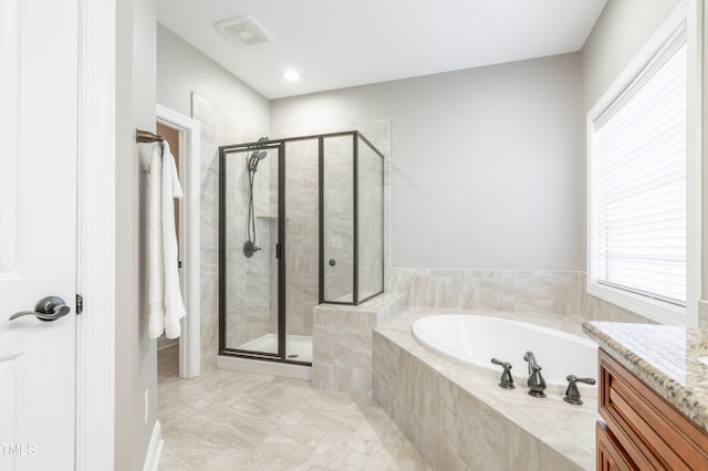 bathroom with vanity and plus walk in shower