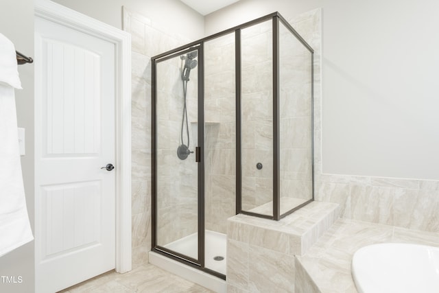 bathroom with shower with separate bathtub