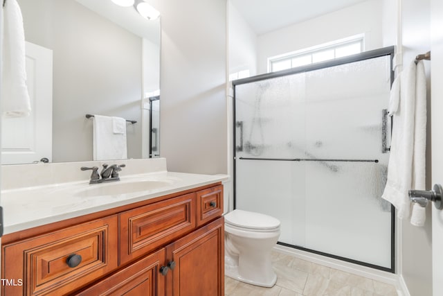 bathroom with tile patterned flooring, vanity, toilet, and an enclosed shower