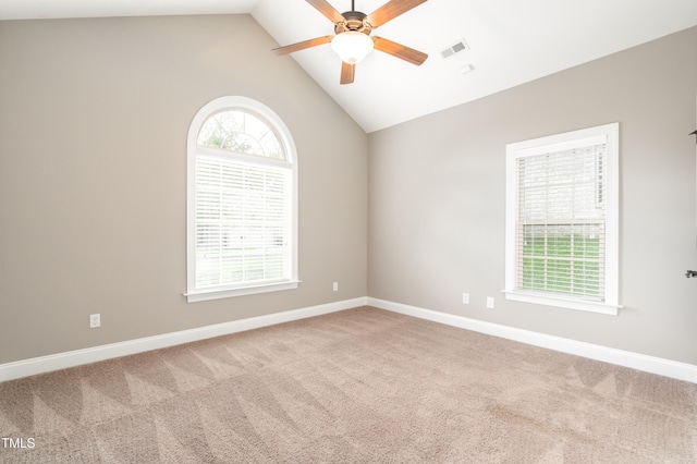 carpeted spare room featuring ceiling fan and lofted ceiling