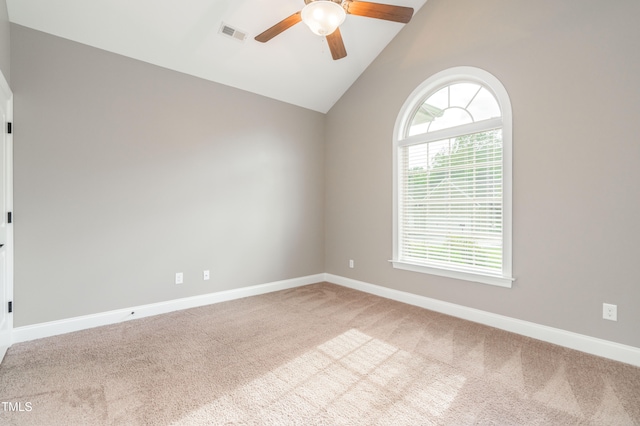 empty room featuring carpet, ceiling fan, and high vaulted ceiling