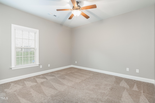 carpeted spare room featuring ceiling fan