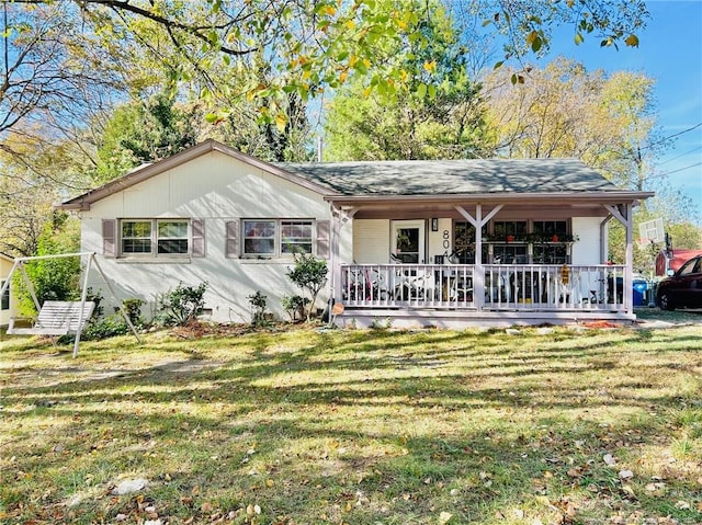 ranch-style house featuring a front lawn and covered porch