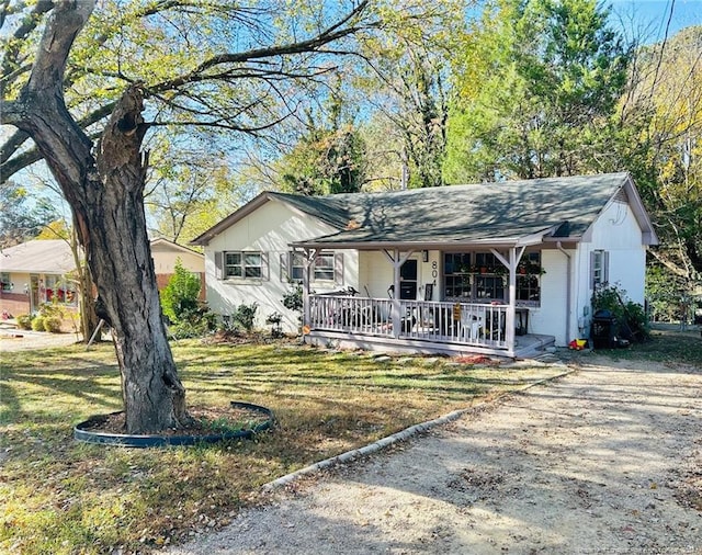 ranch-style home with covered porch and a front yard