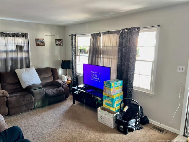 living room with carpet flooring and plenty of natural light