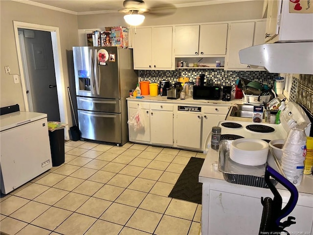 kitchen with white cabinets, stainless steel fridge, white fridge, and exhaust hood