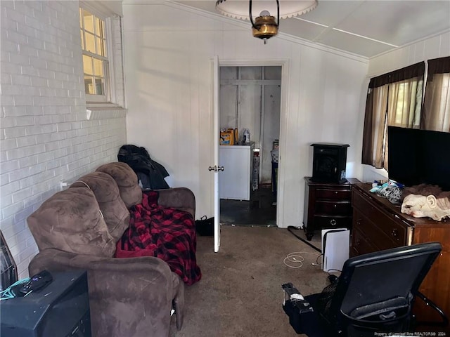 living room with carpet floors, ornamental molding, and brick wall