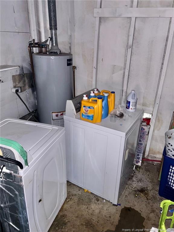 laundry area with washer and dryer and water heater