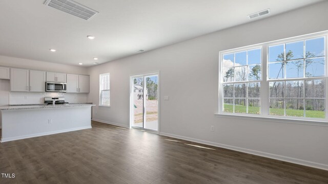 kitchen featuring white cabinets, white range, light stone counters, tasteful backsplash, and dark hardwood / wood-style flooring