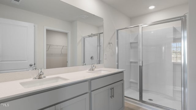 bathroom featuring vanity and an enclosed shower