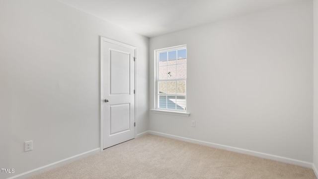 spare room with light colored carpet