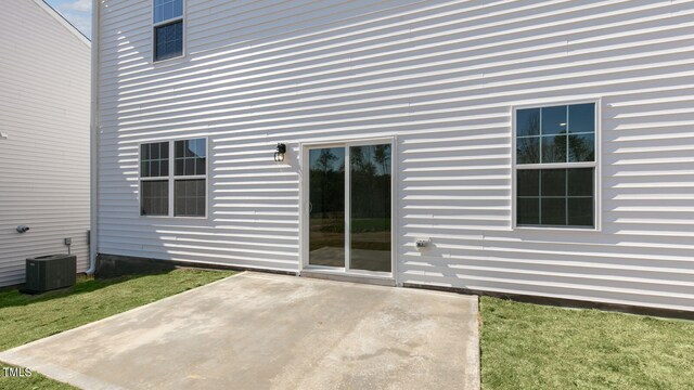 exterior space featuring a lawn, a patio, and central AC