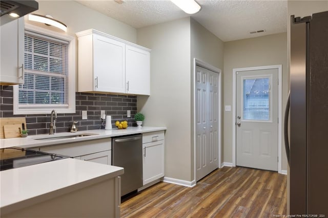 kitchen featuring a textured ceiling, white cabinetry, sink, and appliances with stainless steel finishes