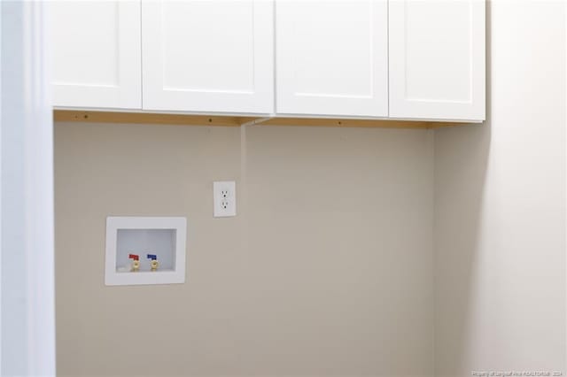 laundry room featuring hookup for a washing machine and cabinets