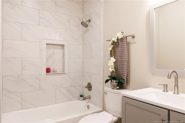 full bathroom featuring vanity, toilet, and tiled shower / bath