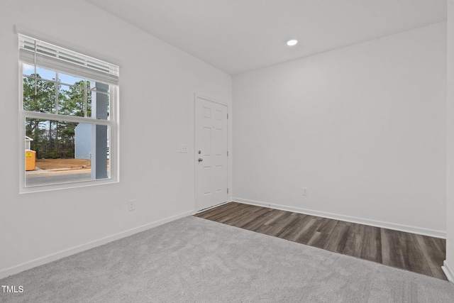 unfurnished room with wood-type flooring