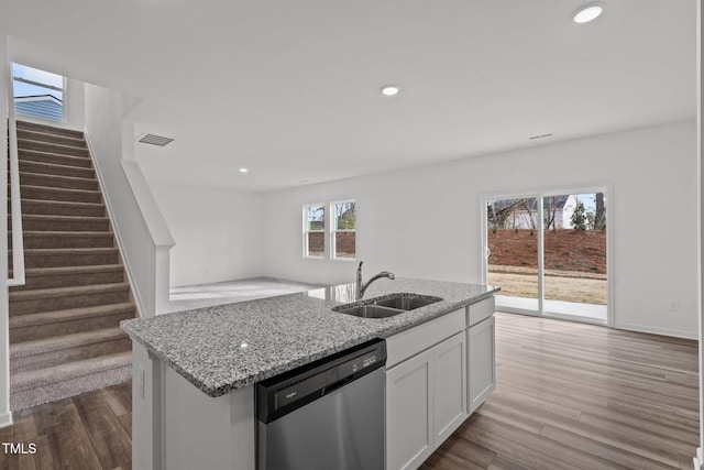 kitchen featuring sink, white cabinets, stainless steel dishwasher, and light hardwood / wood-style flooring