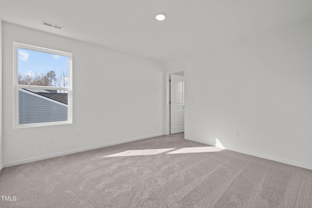 unfurnished room featuring light carpet