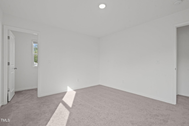 unfurnished room with light carpet