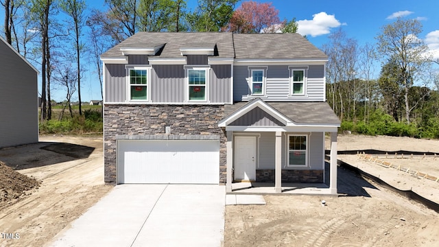 view of front of property with a porch and a garage