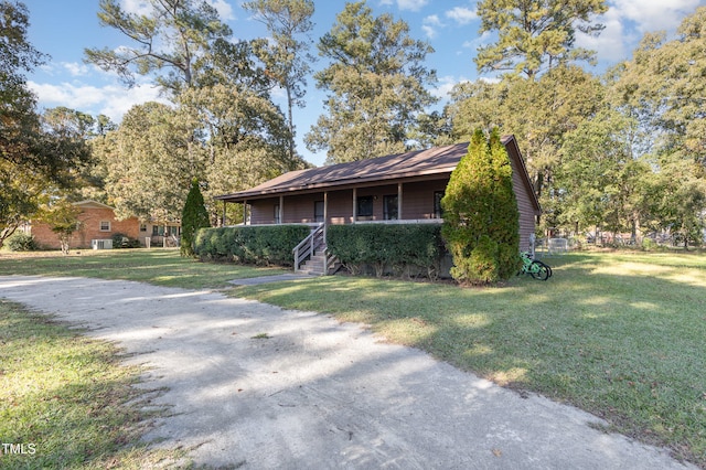 view of front of property with covered porch and a front lawn