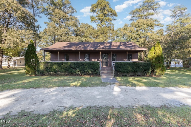 ranch-style house featuring a porch and a front yard