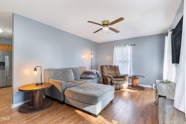 living room featuring ceiling fan and hardwood / wood-style floors