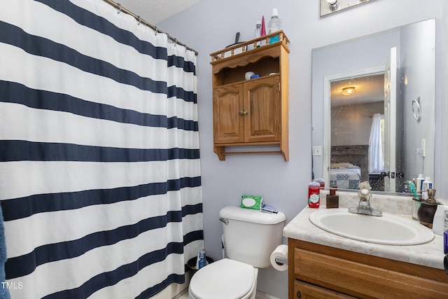 bathroom with a shower with shower curtain, vanity, toilet, and a textured ceiling