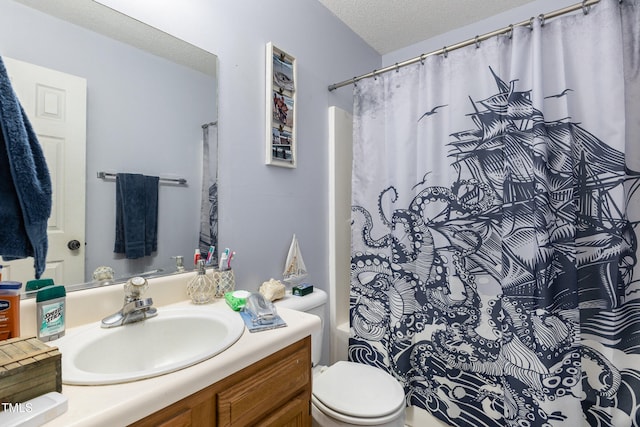 bathroom with vanity, a textured ceiling, and toilet