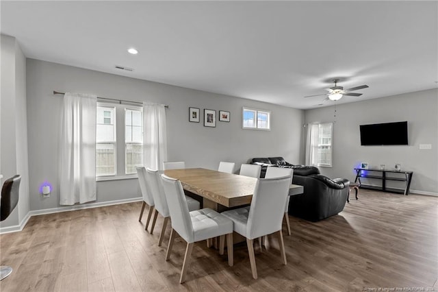 dining room with ceiling fan and wood-type flooring