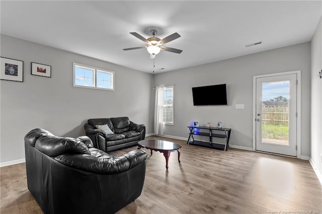 living room with ceiling fan, light hardwood / wood-style flooring, and a healthy amount of sunlight