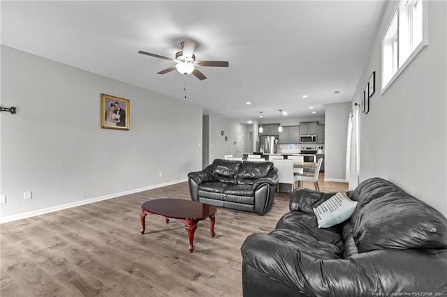 living room featuring hardwood / wood-style flooring and ceiling fan