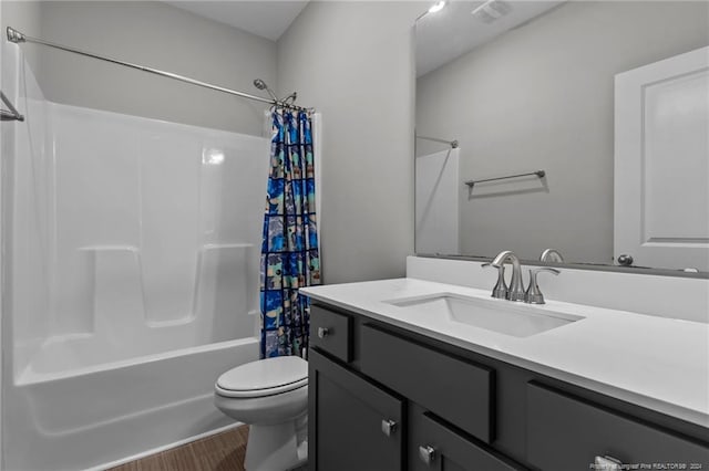 full bathroom featuring toilet, wood-type flooring, vanity, and shower / tub combo with curtain