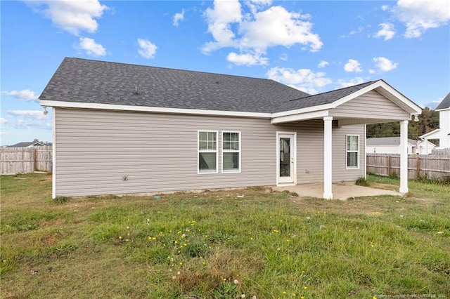 back of property featuring a lawn and a patio