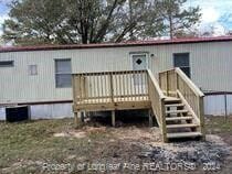 rear view of property featuring a deck